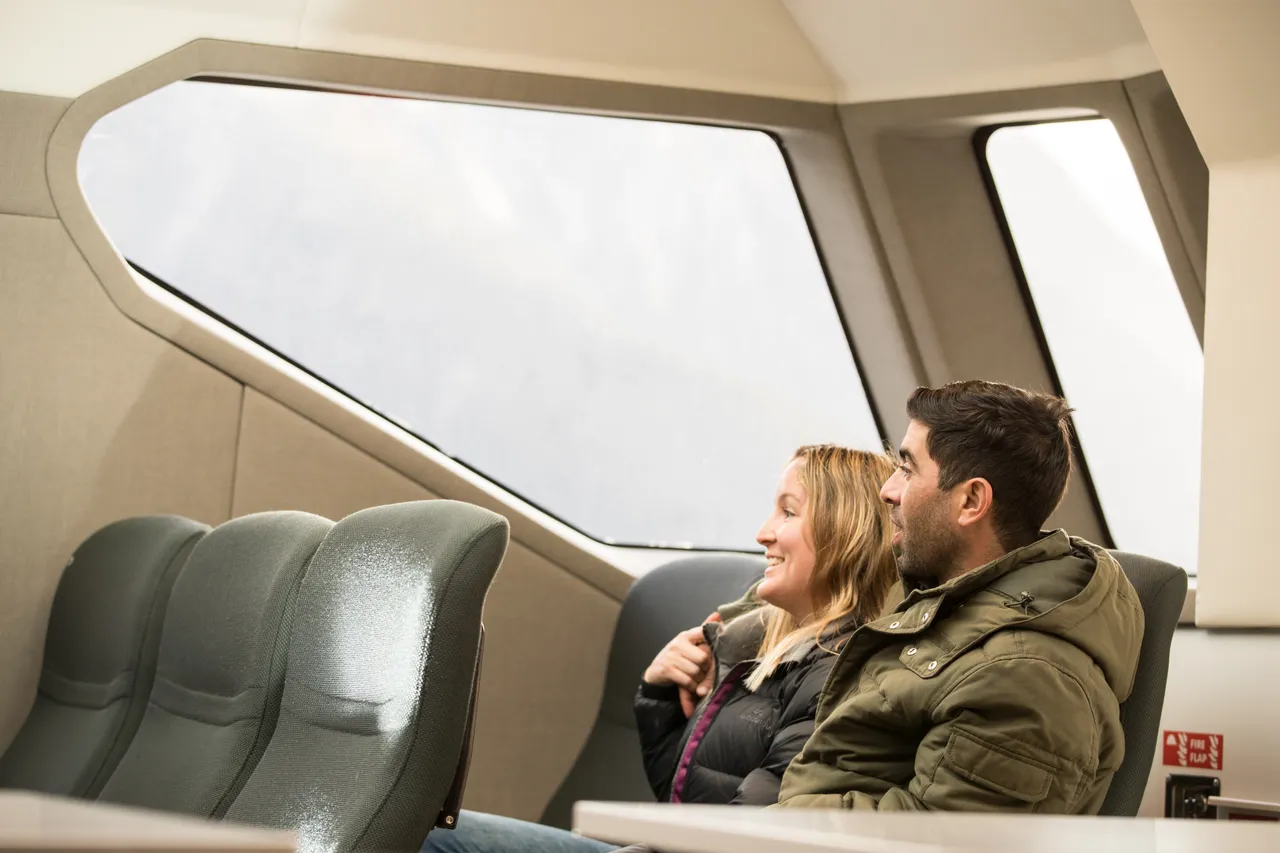 European couple seated inside on Milford Sound cruise