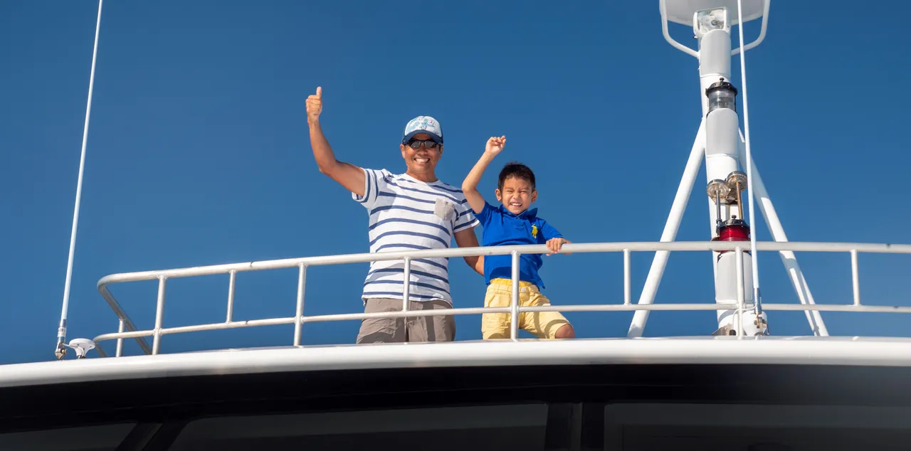 Asian father and son looking down to the camera