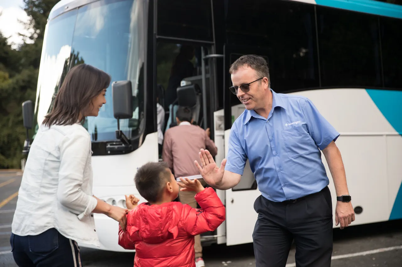 GreatSights driver high fives Chinese guest boarding coach