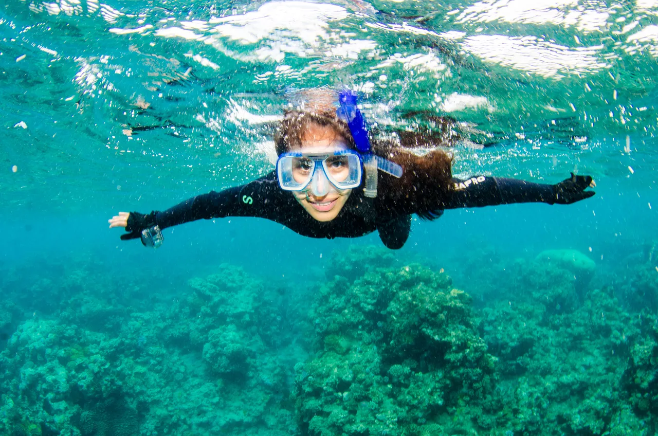 Lady snorkeling near surface of water