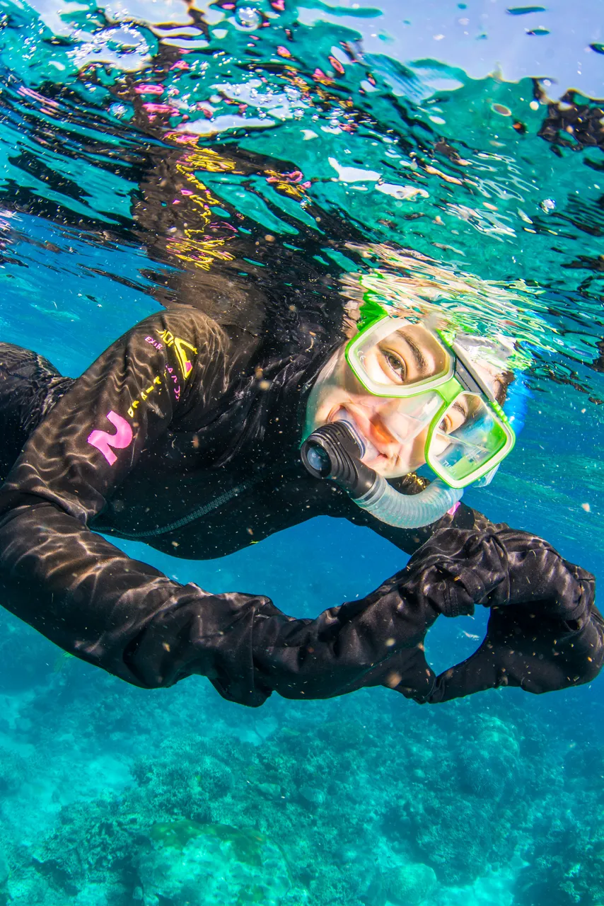 European female snorkeling and posing to the camera