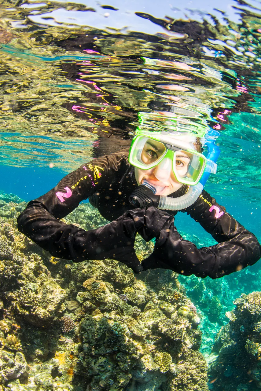 European female snorkeling and posing to the camera