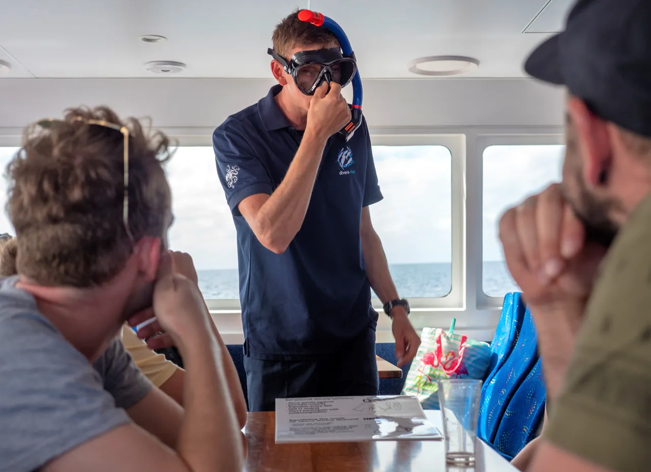 Snorkeling instructor teaching passengers indoors