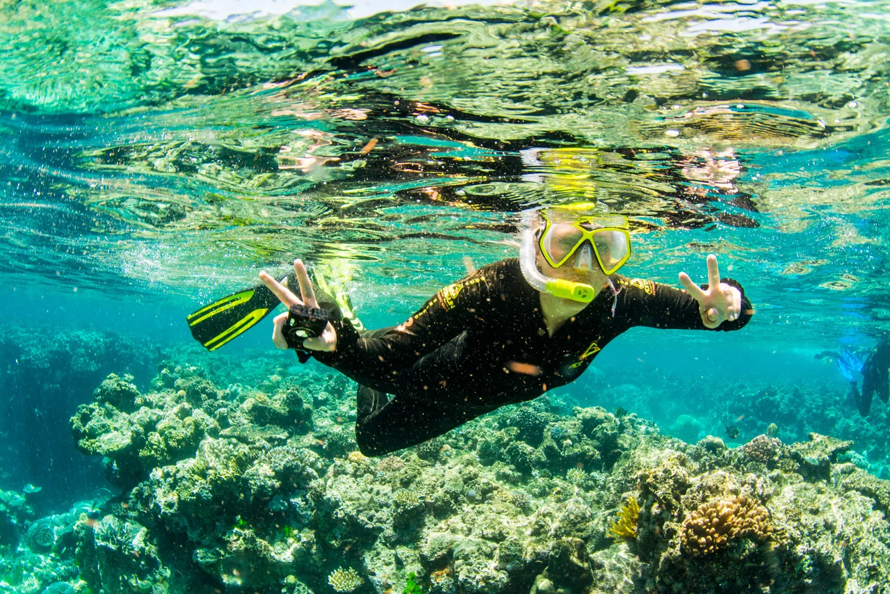 European female snorkeling and posing to the camera