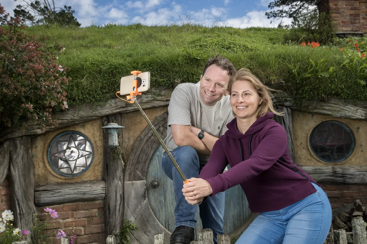 European couple taking selfie at Hobbiton