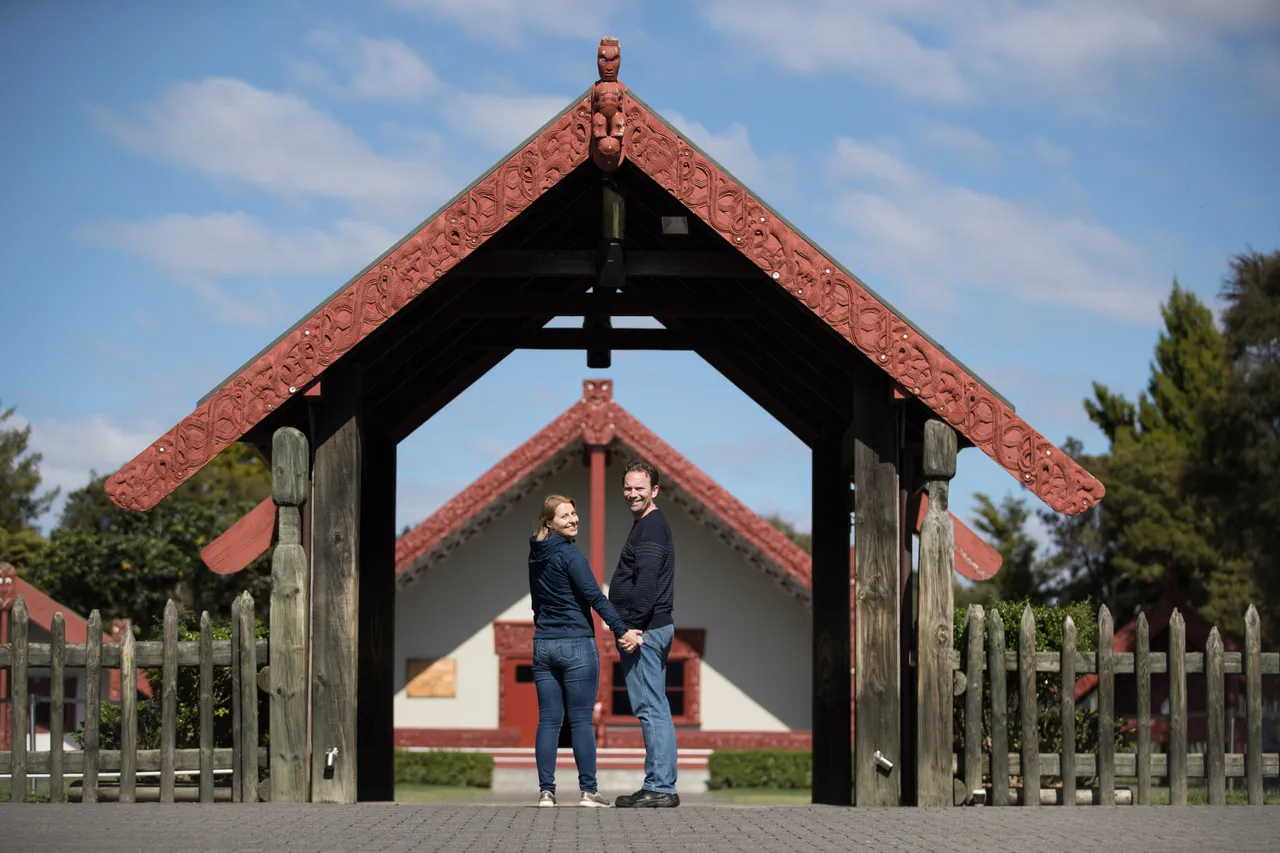 Couple standing in front of marae at Te Puia
