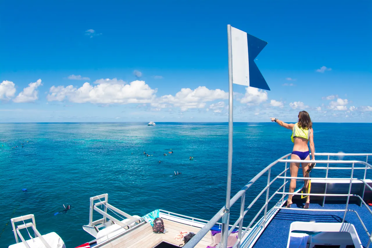 Female staff standing by the handrails of the vessel