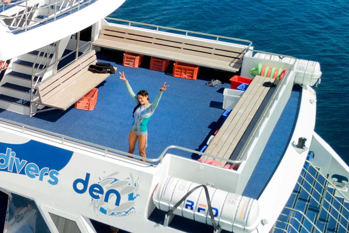 Woman standing on the sundeck of AquaQuest vessel