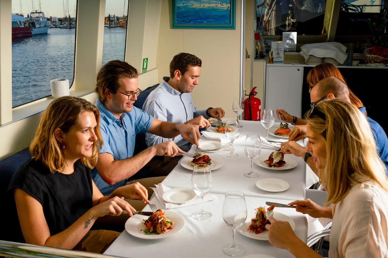 Group eating dinner cruise on the Spirit of Cairns