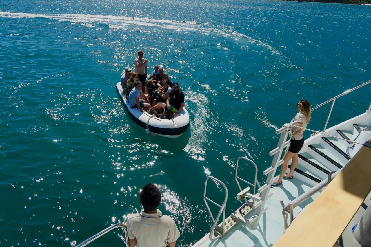 Group on small boat next to Spirit of Freedom