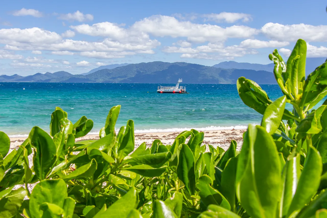 View of Normanby Island beach with Frankland Islands vessel