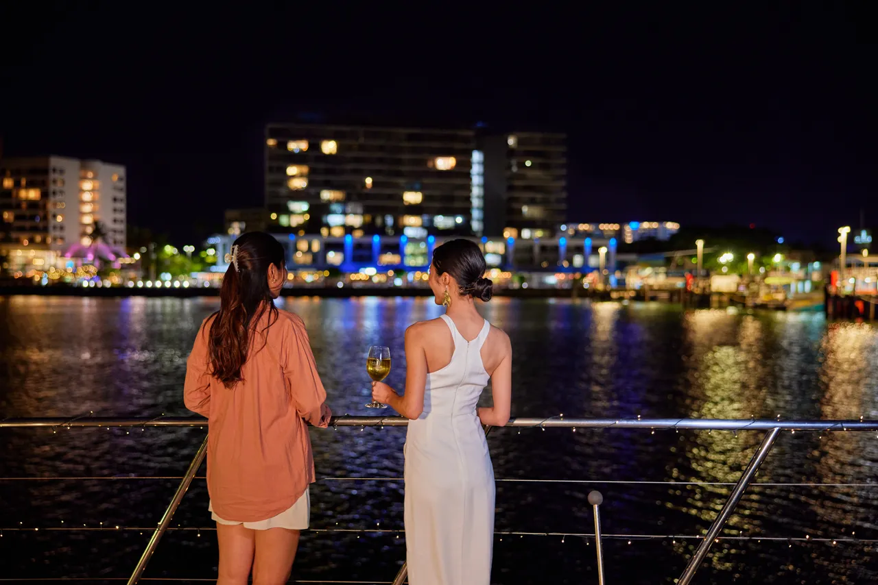 Ladies having a drink on the deck of Spirit of Cairns at nighttime