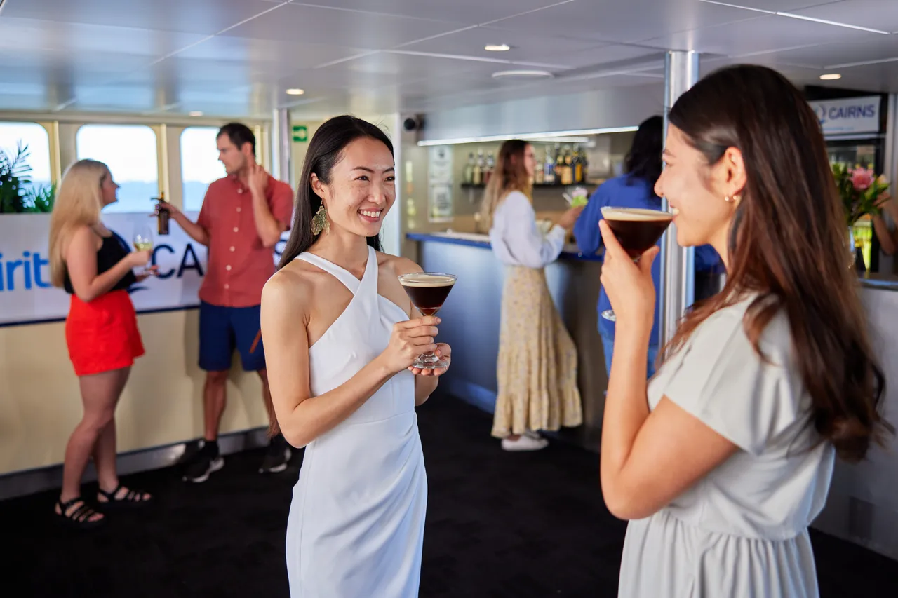 Passengers having a drink in the bar area on Spirit of Cairns