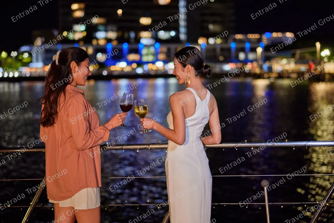 Ladies having a drink on the deck of Spirit of Cairns at nighttime