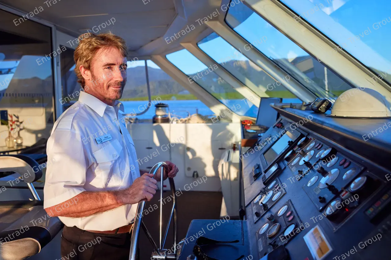 Captain in the wheelhouse of Spirit of Cairns
