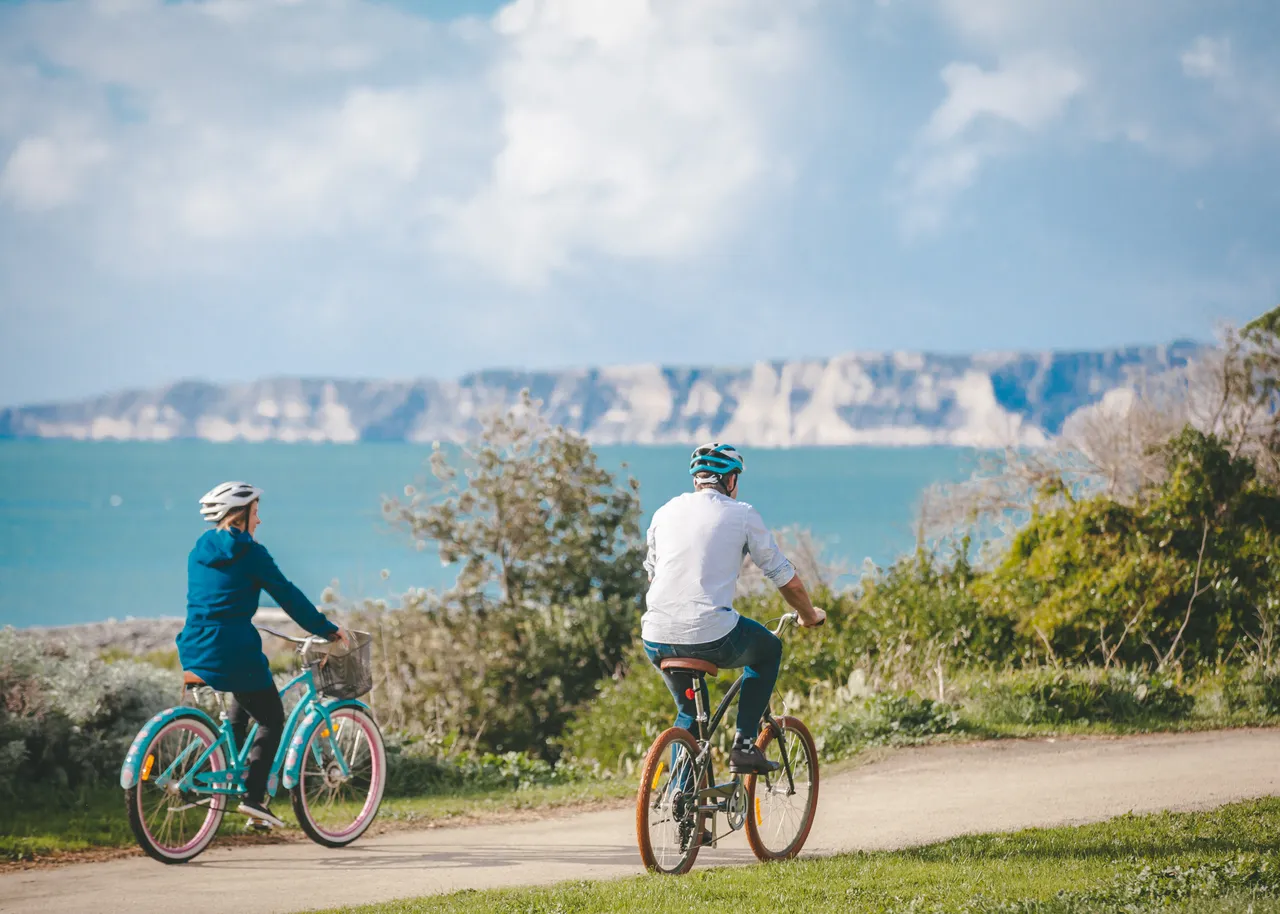 Couple biking along Cape Kidnappers Coast