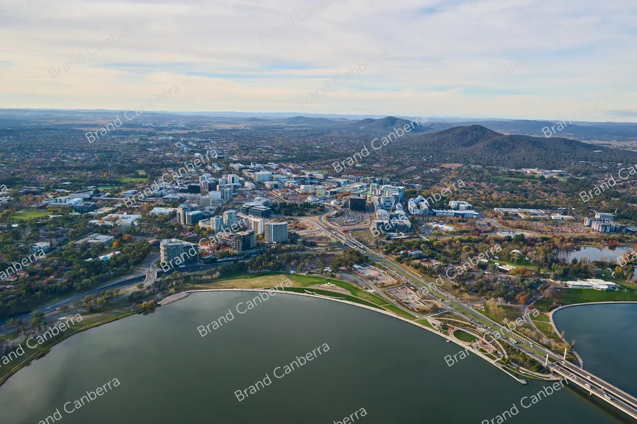 An aerial view over Canberra CBD facing north with Acton Waterfront, Henry Rolland Park, and City Hill in view