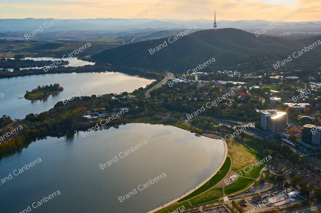 An aerial view over Canberra facing west with Acton Waterfron in view and Telstra Tower in the distance