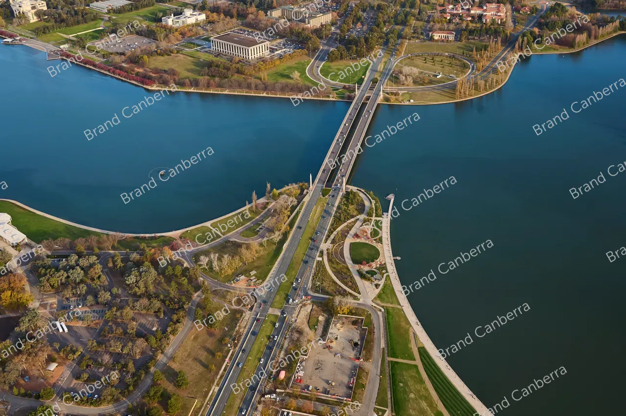 An aerial view over Canberra along Commonwealth Avenue bridge facing south with Henry Rolland Park in view