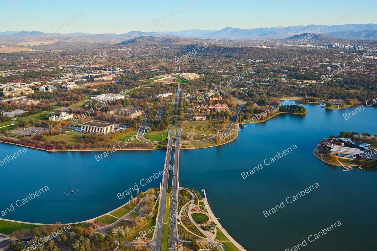 An aerial view over Canberra along Commonwealth Avenue bridge with Australia's Parliament House in view