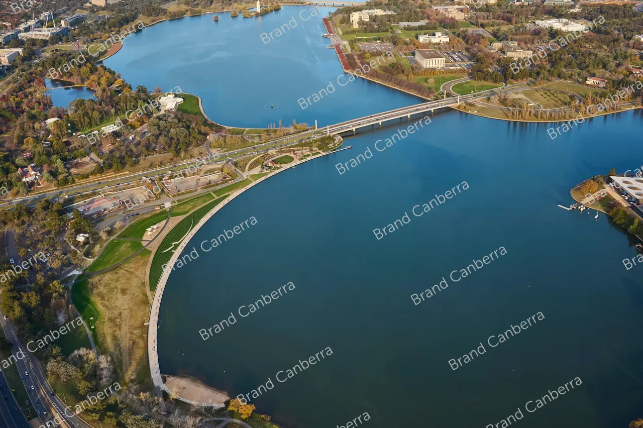 An aerial view over Canberra with Acton Waterfront, Henry Rolland Park, and Commonwealth Avenue bridge in view