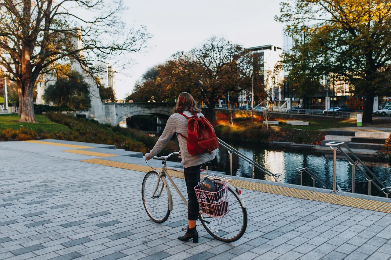 Cyclist by Otakaro Avon River and Bridge of Remembrance