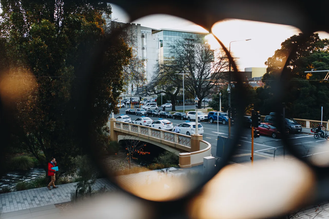 Looking through the balcony balustrade over Otakaro Avon River and bridge
