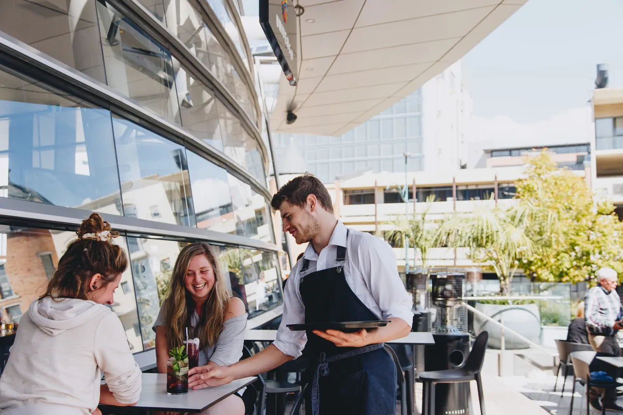 Waiter serving drinks at Universo