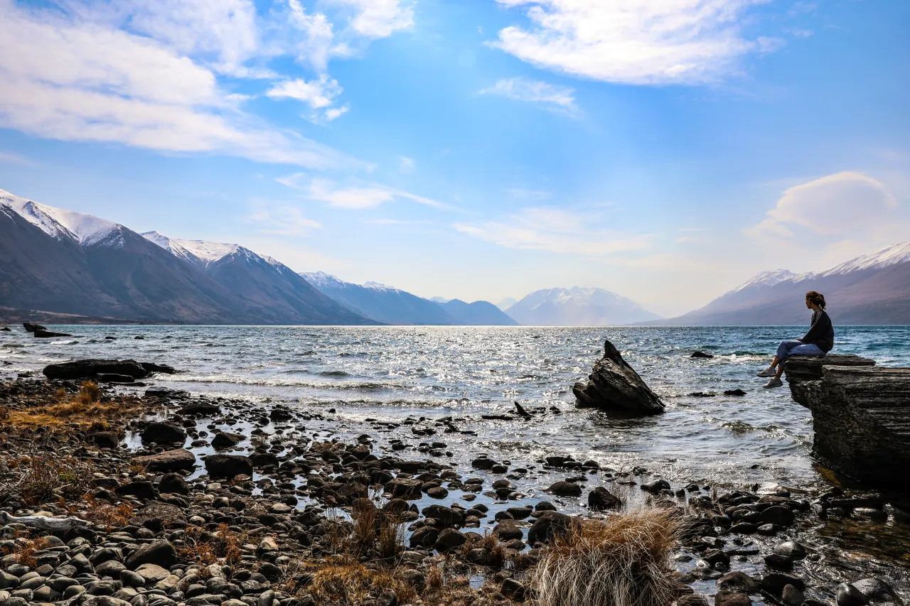 Woman admiring a lake with Mountains