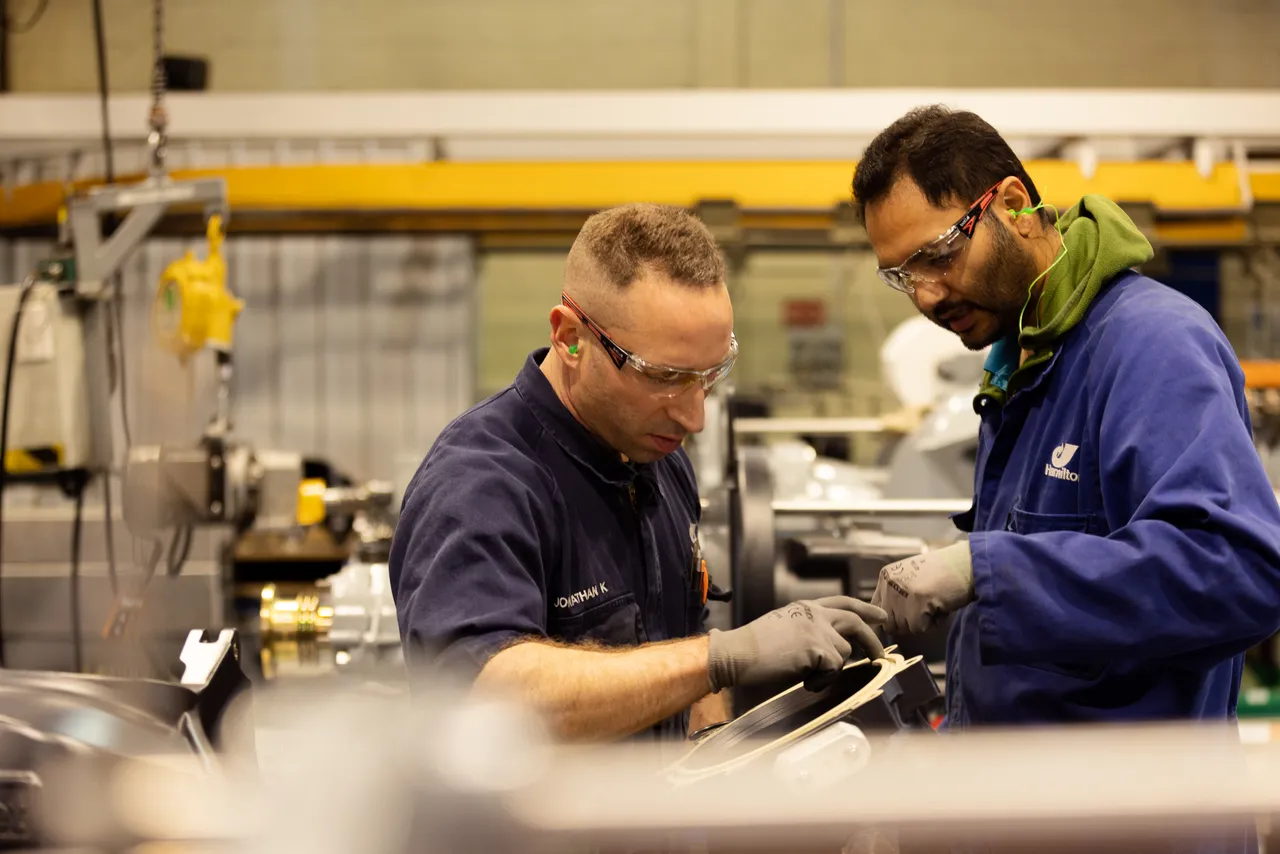 Two men working at small jet assembly