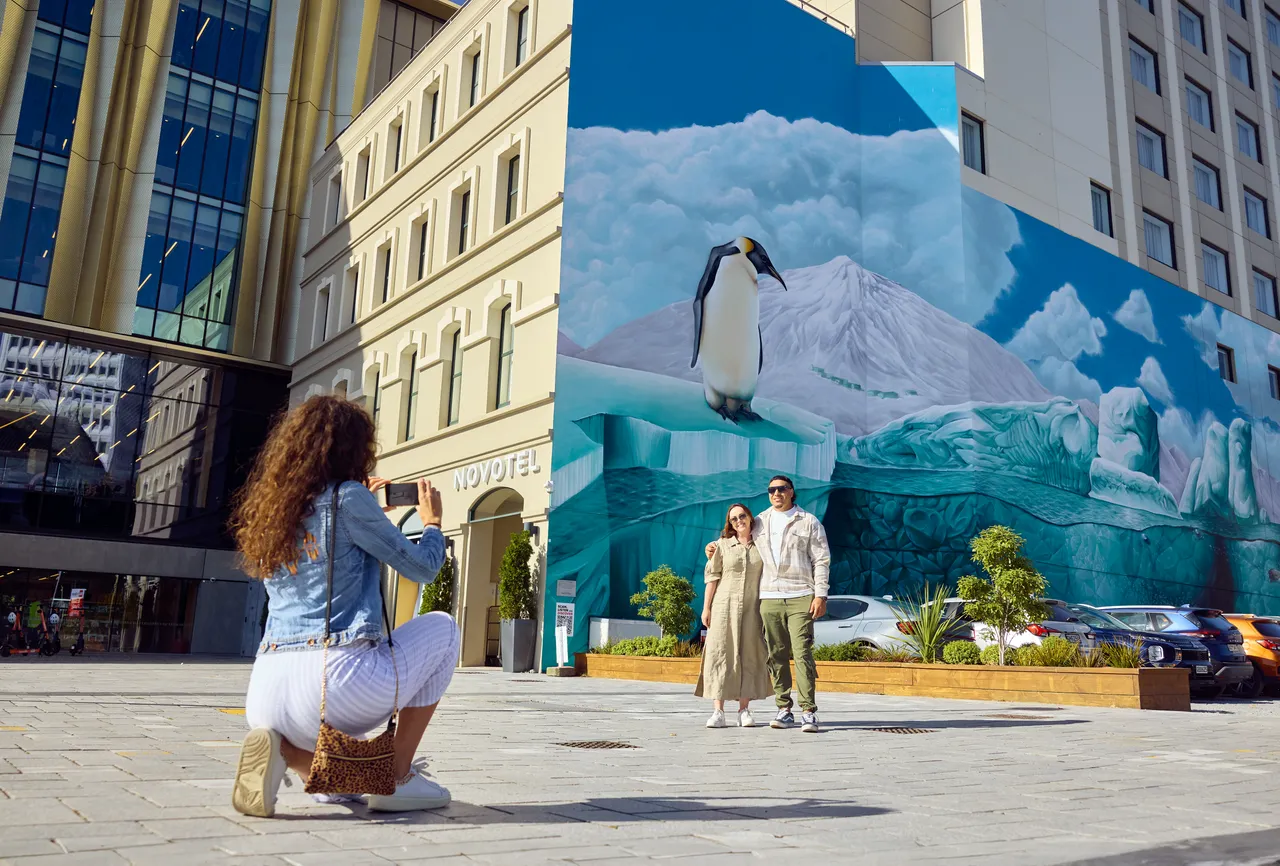 Friends taking photos at the Antarctic Mural