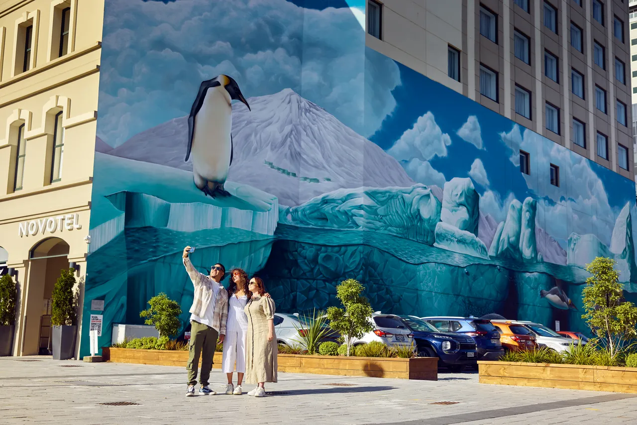 Friends taking photos at the  Antarctic Mural