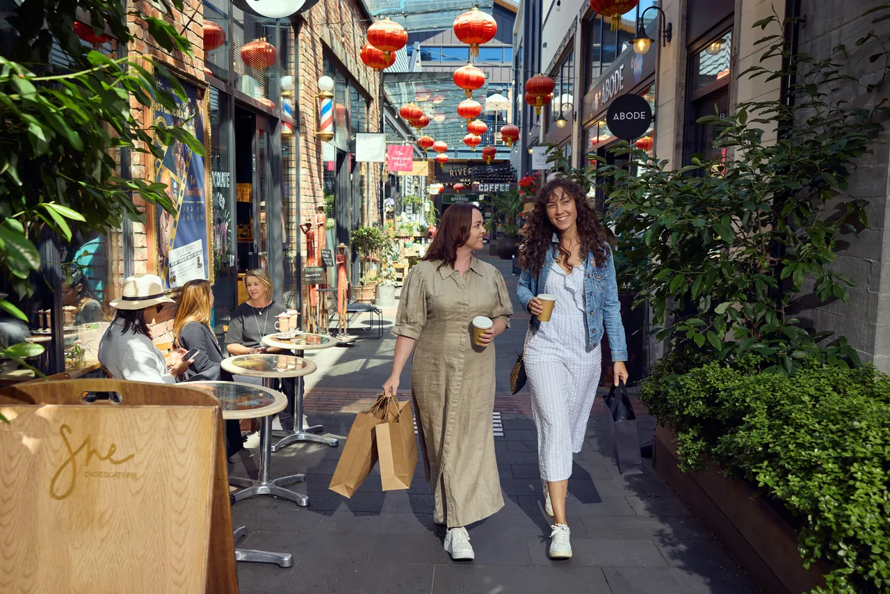 Two friends explore the shops at the Riverside Lanes