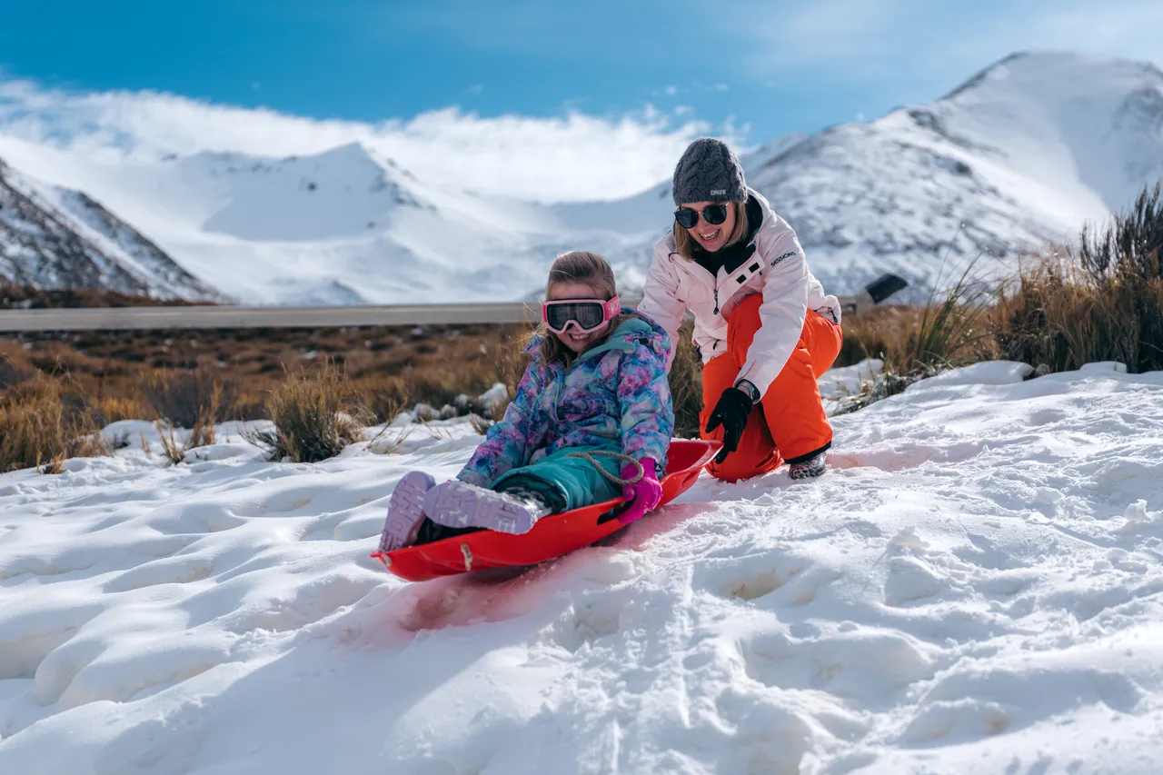 Mom and child tobogganing