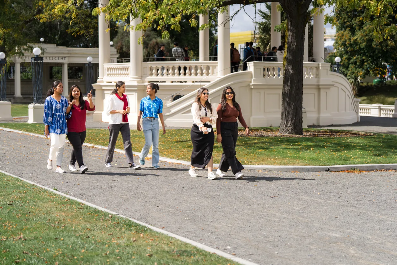 Students walking by Ōtākaro Avon River path