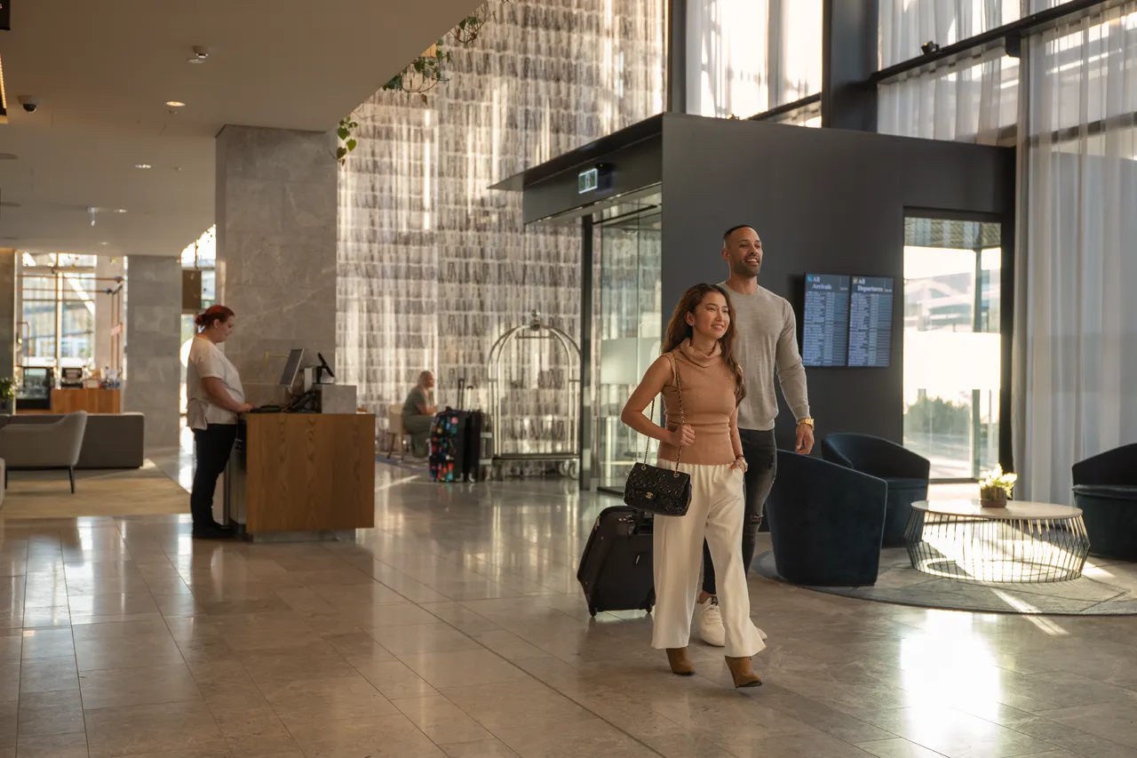 Couple entering hotel foyer