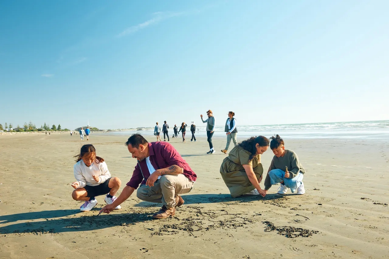 Family playing on the sand at Sumner Beach