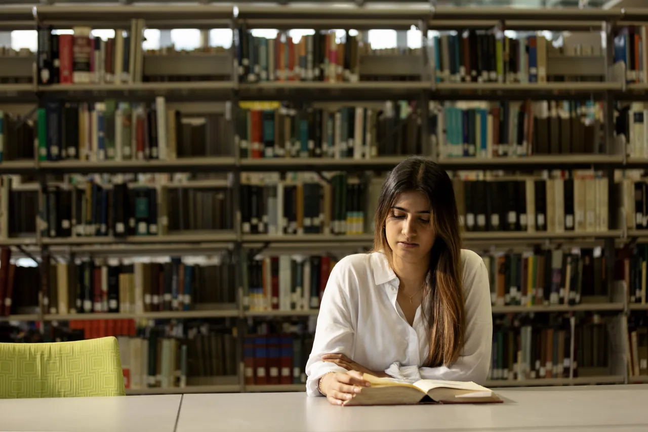 Tertiary student in library