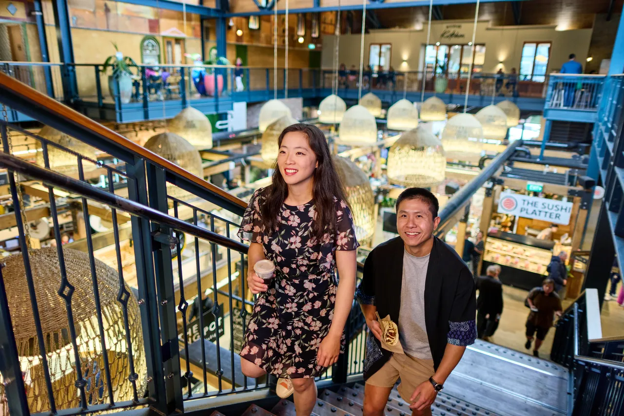 Couple going upstairs of Riverside Market