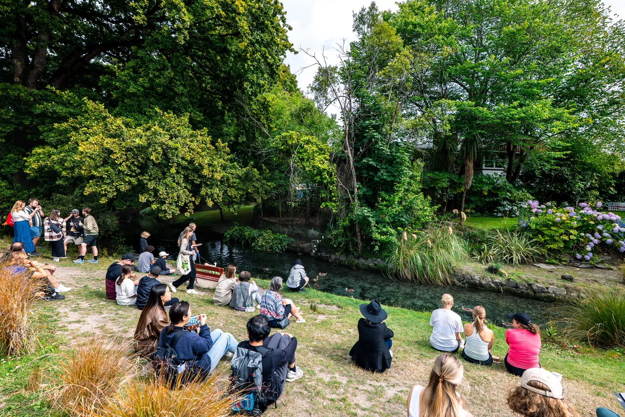 People sitting by the Avon River