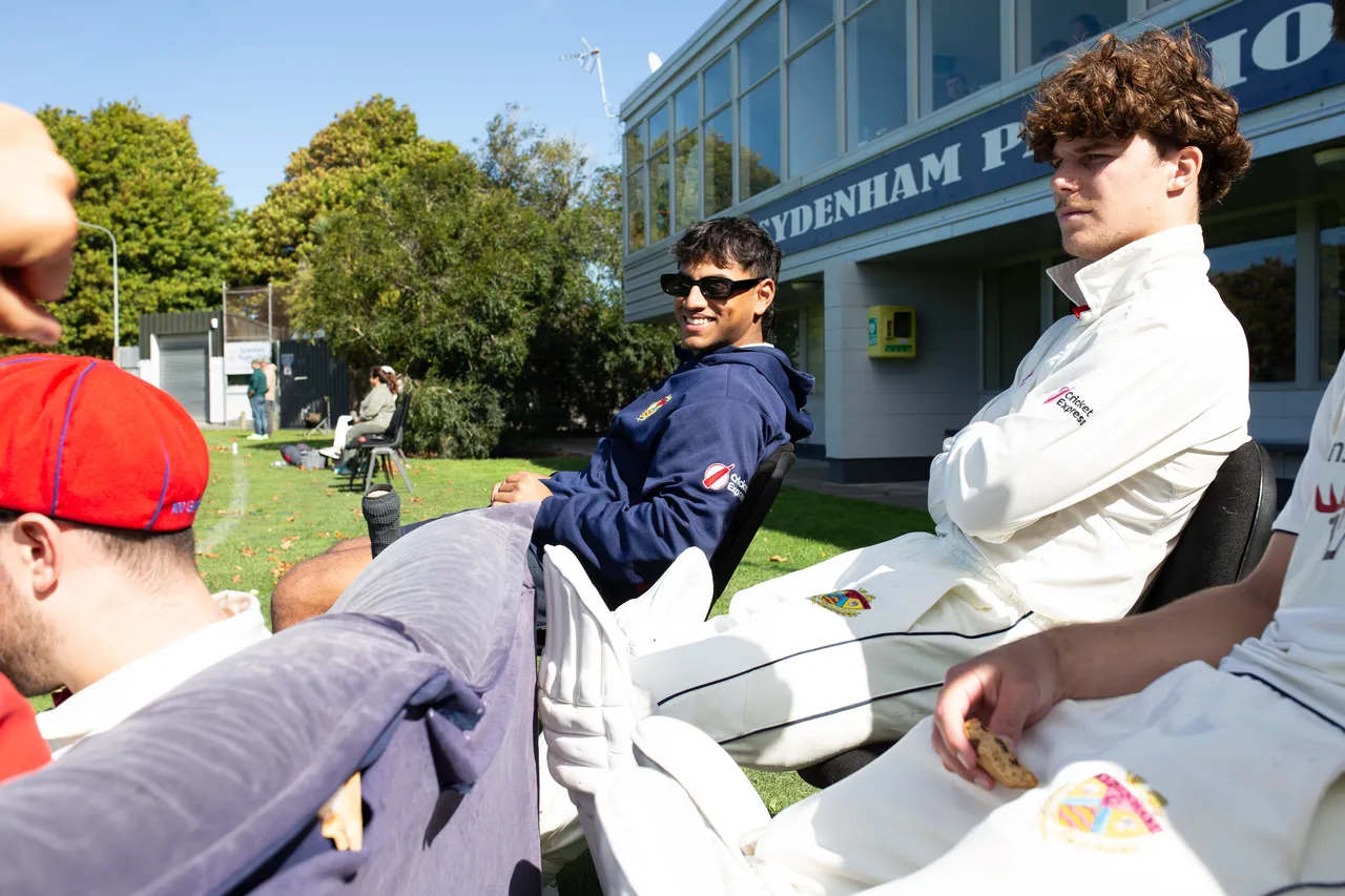 Students enjoying downtime of cricket game