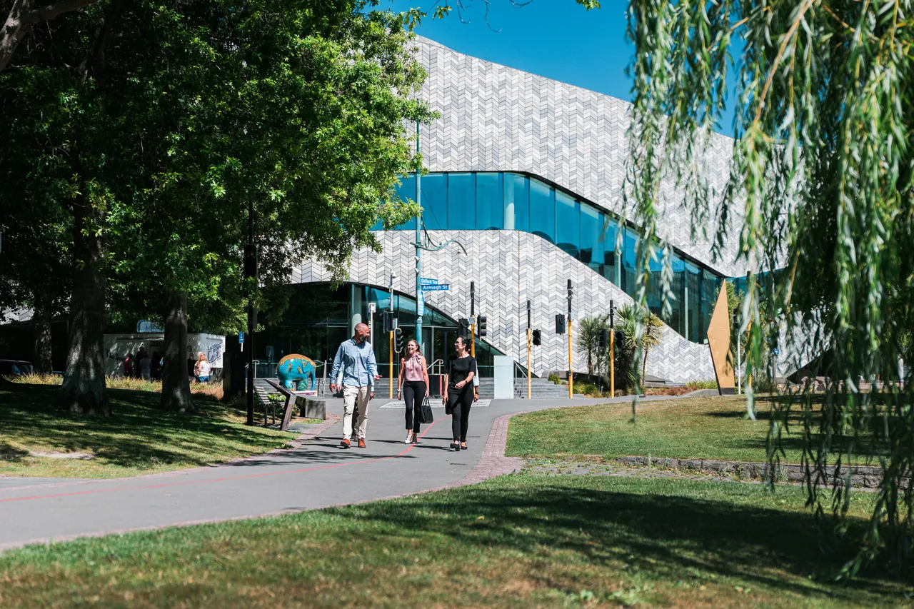 Three delegates walking at the park 