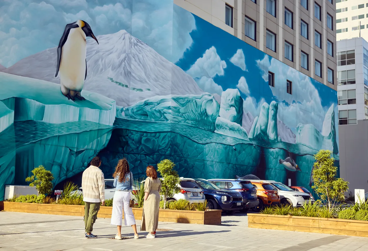 Three friends admiring the Antarctic Mural