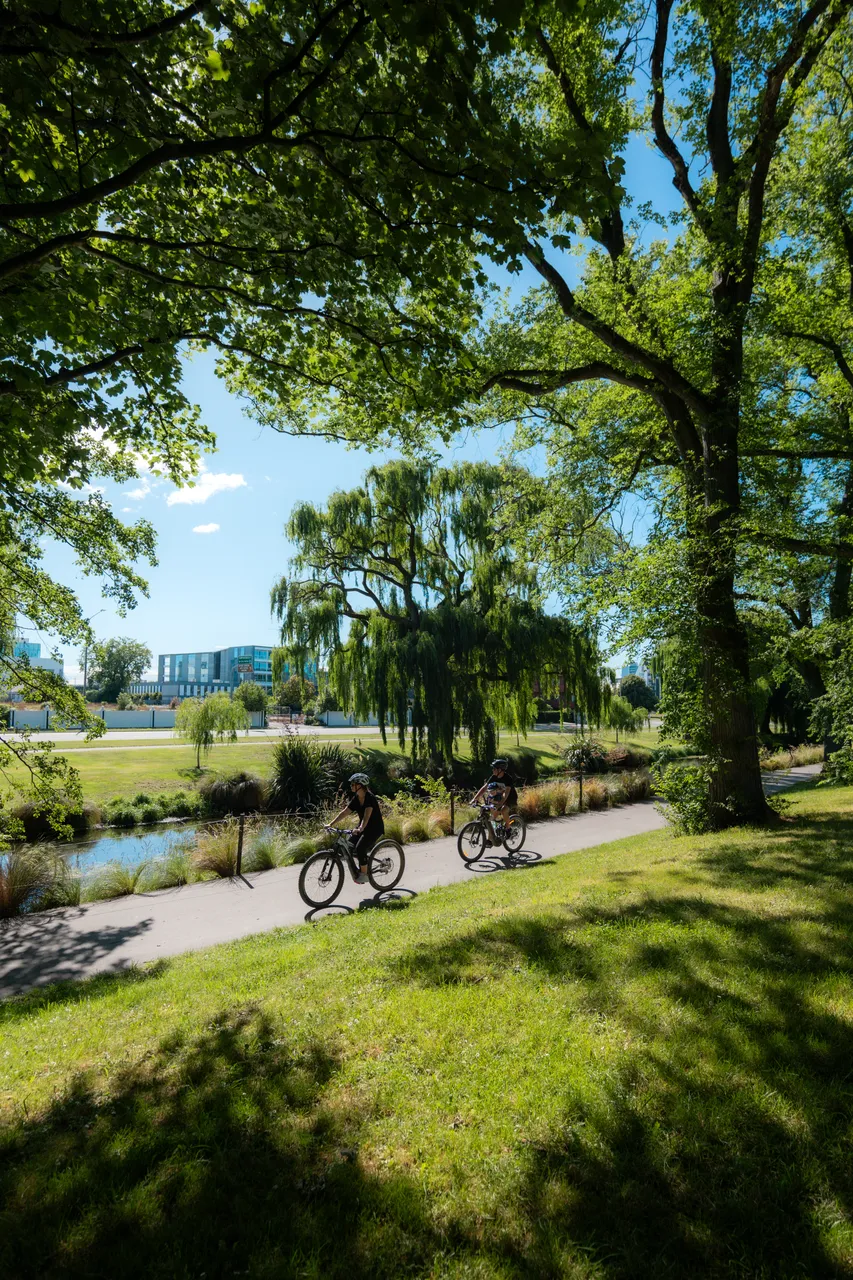 Two bikers along Avon/Ōtākaro River