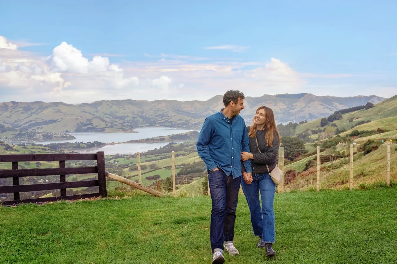 Couple walking with the Banks Peninsula backdrop