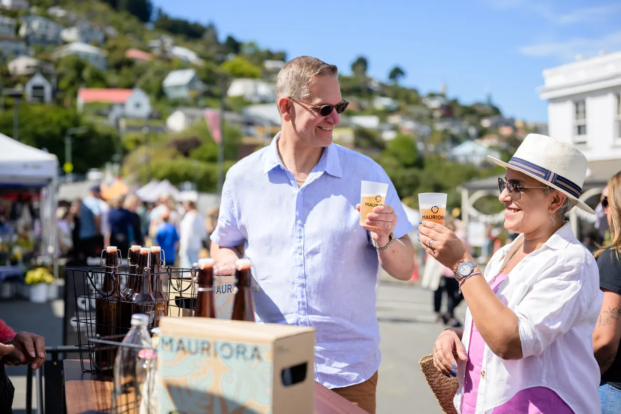 Couple tries Mauriora Kombucha at the Lyttelton Farmers Market