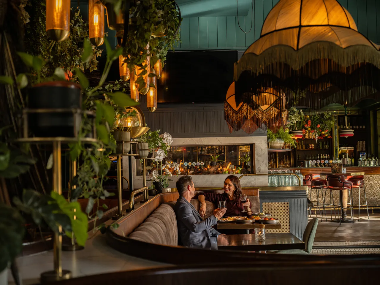 Couple enjoying food and drinks at Amazonita