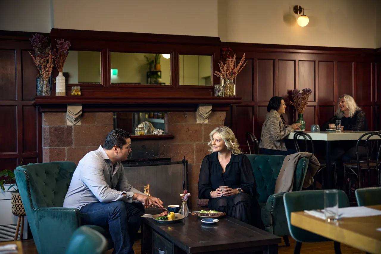 Couple having brunch by the fire at Miro