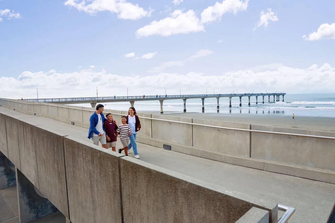 Family strolling by New Brighton pier